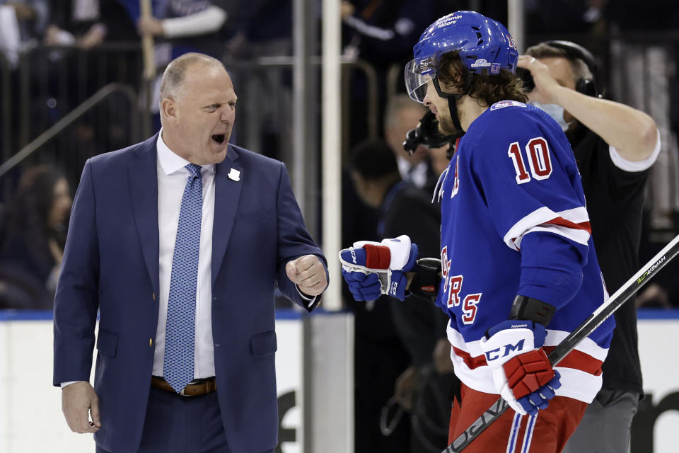 New York Rangers head coach Gerard Gallant fist bumps Rangers left wing Artemi Panarin (10) after Panarin scored the game winning goal against the Pittsburgh Penguins during overtime in Game 7 of an NHL hockey Stanley Cup first-round playoff series Sunday, May 15, 2022, in New York. The Rangers won 4-3 in overtime. (AP Photo/Adam Hunger)