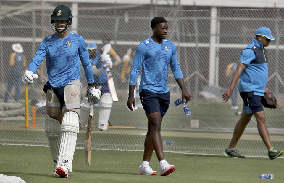 South Africa's Dean Elgar, left, and Lutho Sipamla, center, attend a practice session at the National Cricket Stadium, in Karachi, Pakistan, Saturday, Jan. 23, 2021. South Africa, which arrived in the southern port city of Karachi for the first time in nearly 14 years, will play the first cricket test match against Pakistan starting on Jan. 26. (AP Photo/Fareed Khan)