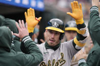 Oakland Athletics' Brent Rooker is greeted in the dugout after his two-run home run during the sixth inning of a baseball game against the Detroit Tigers, Friday, April 5, 2024, in Detroit. (AP Photo/Carlos Osorio)