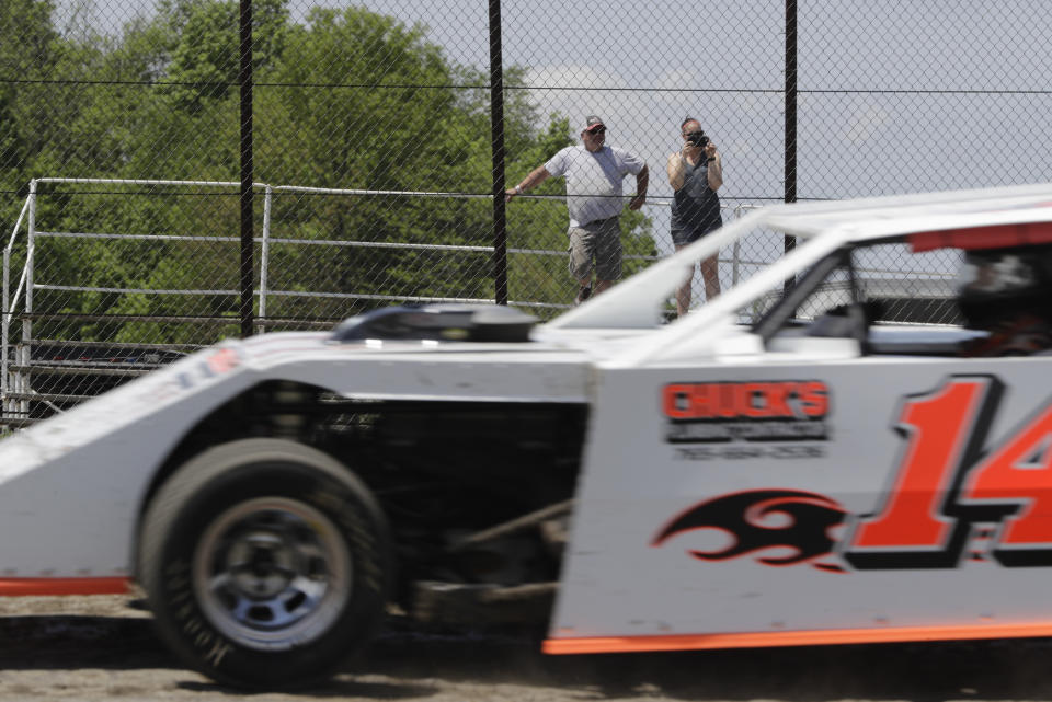 Fans watch as cars practice at Gas City I-69 Speedway, Sunday, May 24, 2020, in Gas City, Ind. (AP Photo/Darron Cummings)