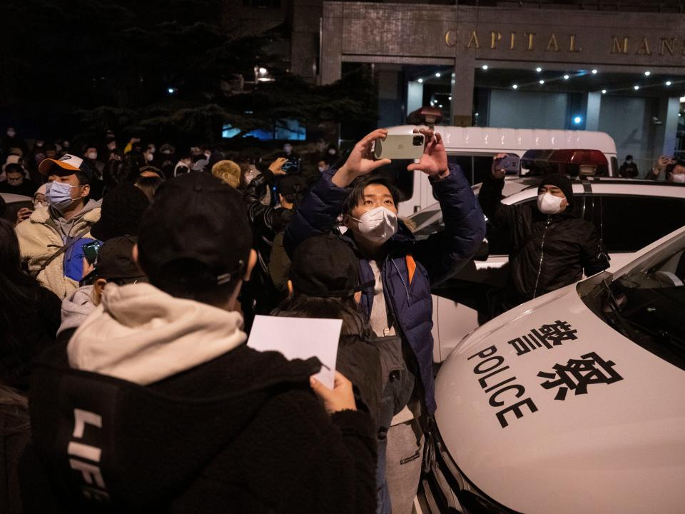 Protesters clash with policemen during a protest in Beijing, Sunday, Nov. 27, 2022.