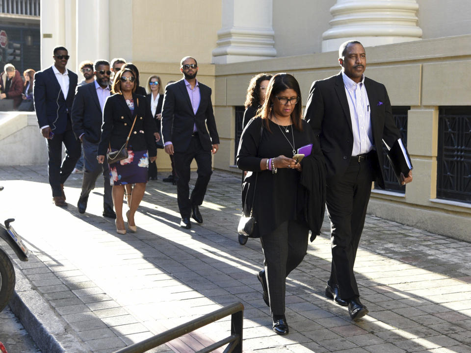 Phil and Jill Henderson, front, parents of Bakari Henderson, arrive at the court house in Patras, Greece, on Thursday, Nov. 22, 2018. A Greek court on Thursday convicted and sentenced six of nine suspects in the fatal beating of an American tourist in an island resort last year. Bakari Henderson, a 22-year-old of Austin, Texas, died after being beaten in the street following an argument in a bar in the popular Laganas resort area of Zakynthos island in July 2017. (AP Photo/Giannis Androutsopoulos)