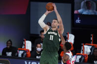 Milwaukee Bucks' Brook Lopez (11) shoots during the first half of an NBA basketball game against the Washington Wizards, Tuesday, Aug. 11, 2020, in Lake Buena Vista, Fla. (AP Photo/Ashley Landis, Pool)