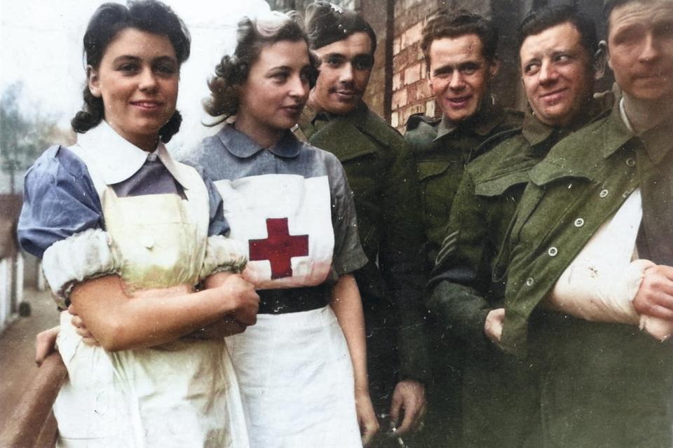 A colourised version of VAD (Voluntary Aid Detachment) nurses with wounded D-Day soldiers at Cowley Hospital in Oxford in 1945 (British Red Cross/PA)