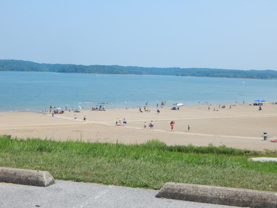 People enjoy the last days of summer at the beach at Patoka Lake.