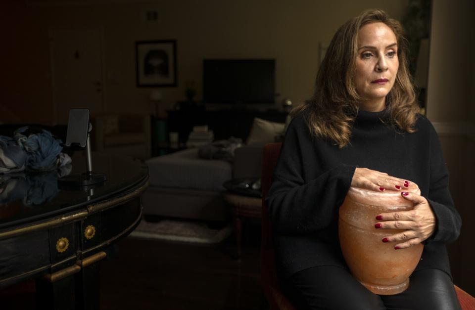Helena Apothaker holds an urn containing her mother's ashes in West Hollywood.
