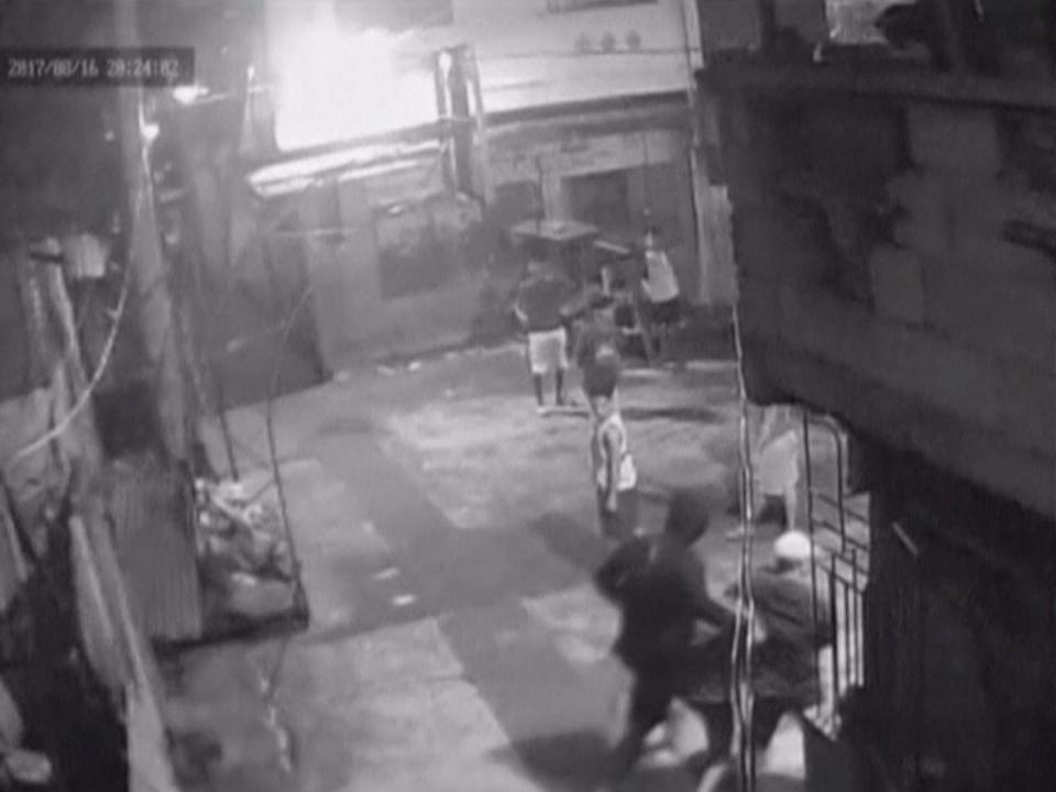 CCTV footage appearing to show Kian Loyd delos Santos being dragged by plain-clothed police past a basketball court in Caloocan City Barangay, Philippines (Reuters)