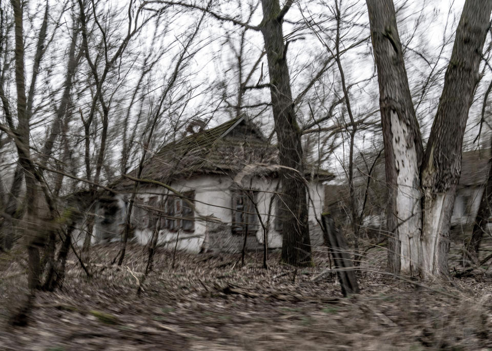 Abandoned country houses are seen at the Chernobyl exclusion zone, Ukraine, Tuesday, April 13, 2021. The Ukrainian authorities are calling for the exclusion zone of objects to be included in the UNESCO World Heritage List, since the object is a unique place "of interest to all mankind". The Ministry of Culture of Ukraine has already taken steps to recognize the zone as a monument, which will attract more funding and tourists. (AP Photo/Evgeniy Maloletka)