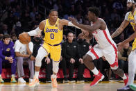 Los Angeles Lakers guard Russell Westbrook (0) is defended by Houston Rockets forward Jae'Sean Tate (8) during the first half of an NBA basketball game Tuesday, Nov. 2, 2021, in Los Angeles. (AP Photo/Marcio Jose Sanchez)