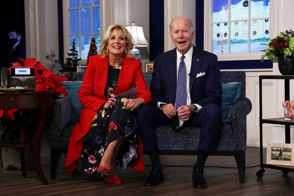 President Joe Biden and first lady Dr. Jill Biden participate in an event to call NORAD and track the path of Santa Claus on Christmas Eve in the South Court Auditorium of the Eisenhower Executive Building on Dec. 24, 2021, in Washington.