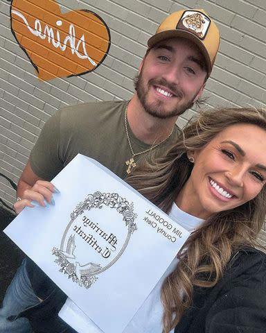 <p>KT Smith/Instagram</p> KT Smith and her husband with their marriage certificate in April 2024