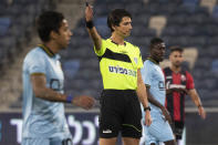 Referee Sapir Berman works during an Israeli Premier League soccer match between Hapoel Haifa and Beitar Jerusalem in the northern Israeli city of Haifa, Monday, May 3, 2021. Israeli soccer's first transgender soccer referee took the field Monday for the first time since coming out publicly as a woman last week. (AP Photo/Sebastian Scheiner)