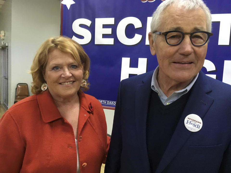 North Dakota Democratic Sen. Heidi Heitkamp and former Republican senator and Defense Secretary Chuck Hagel pose for a photo on Tuesday, Oct. 23, 2018 in Bismarck, North Dakota. Hagel is campaigning across the state for Heitkamp, who is viewed as one of the most vulnerable candidates among red-state Democrats in the Senate. (AP Photo/James MacPherson)