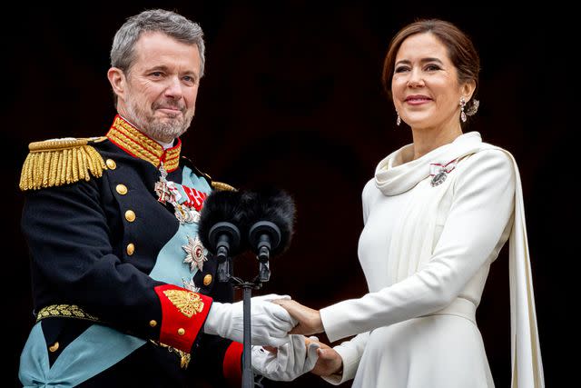 <p>Patrick van Katwijk/Getty</p> King Frederik X of Denmark and Queen Mary of Denmark stand on the balcony of Christiansborg Palace shortly after the proclamation on January 14.