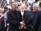 Tom Hanks, from left, and Baz Luhrmann pose for photographers upon arrival at the premiere of the film 'Elvis' at the 75th international film festival, Cannes, southern France, Wednesday, May 25, 2022. (AP Photo/Petros Giannakouris)