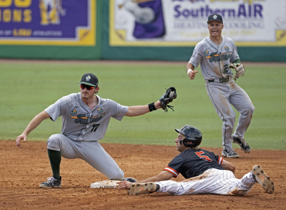 Tulane shortstop Gavin Schulz (2) looks on as Tulane second baseman Brady Hebert (17) holds up the ball after tagging out Sam Houston State's Justin Wishkoski (5) during an NCAA college baseball tournament regional game Saturday, June 3, 2023, in Baton Rouge, La. (Hilary Scheinuk/The Advocate via AP)