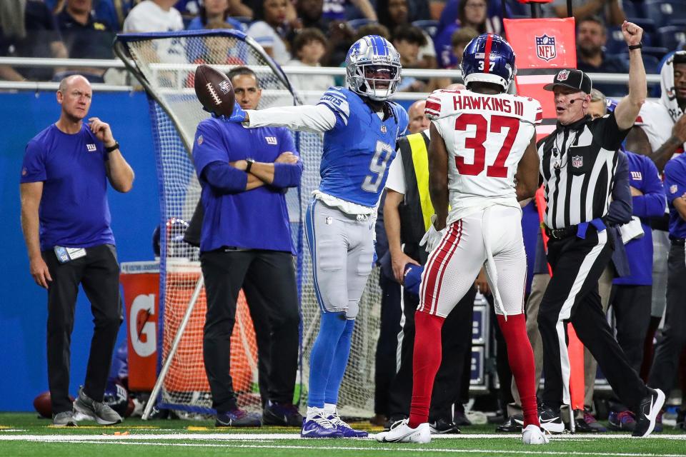 Detroit Lions wide receiver Jameson Williams (9) reacts to a first down catch against New York Giants cornerback Tre Hawkins III (37) during the first half of a preseason game at Ford Field in Detroit on Friday, Aug. 11, 2023.