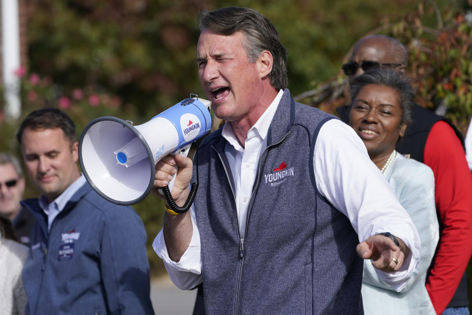 Republican gubernatorial candidate Glenn Youngkin, center, speaks to supporters as running mates Attorney General candidate Jason Miyares, left, and Lt. Gov. gandidate Winsome Sears, right, listen during a rally in Fredericksburg, Va., Saturday, Oct. 30, 2021. Youngkin will face Democrat former Gov. Terry McAuliffe in the November election. (AP Photo/Steve Helber)