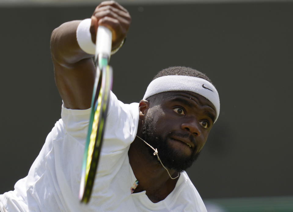 Frances Tiafoe of the US returns to Kazakhstan's Alexander Bublik during their men's third round singles match on day five of the Wimbledon tennis championships in London, Friday, July 1, 2022. (AP Photo/Kirsty Wigglesworth)
