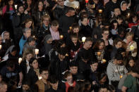 People attend as Pope Francis presides over the Via Crucis (Way of the Cross) torchlight procession on Good Friday, a Christian holiday commemorating the crucifixion of Jesus Christ and his death at Calvary, in front of Rome's Colosseum, in Rome, Friday, April 19, 2019. (AP Photo/Andrew Medichini)