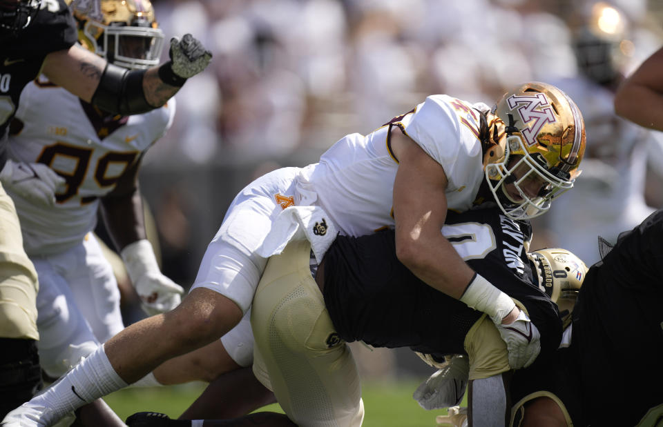 Minnesota linebacker Jack Gibbens, top, wraps up Colorado running back Ashaad Clayton after a short gain in the second half of an NCAA college football game Saturday, Sept. 18, 2021, in Boulder, Colo. Minnesota won 30-0. (AP Photo/David Zalubowski)