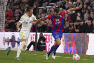 Leeds United's Luke Ayling, left, and Crystal Palace's James McArthur battle for the ball during the English Premier League soccer match between Crystal Palace and Leeds United at Selhurst Park, London, Monday April 25, 2022. (John Walton/PA via AP)