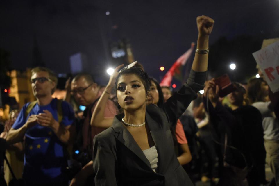 An anti-Brexit protester raises her fist during the demonstration outside Parliament (Getty Images)