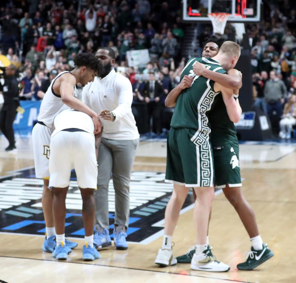 Michigan State Spartans forward Joey Hauser (10) and  guard A.J. Hoggard (11) celebrate the 69-60 win against the Marquette Golden Eagles in the second round of the NCAA tournament in Columbus, Ohio, March 19, 2023.
