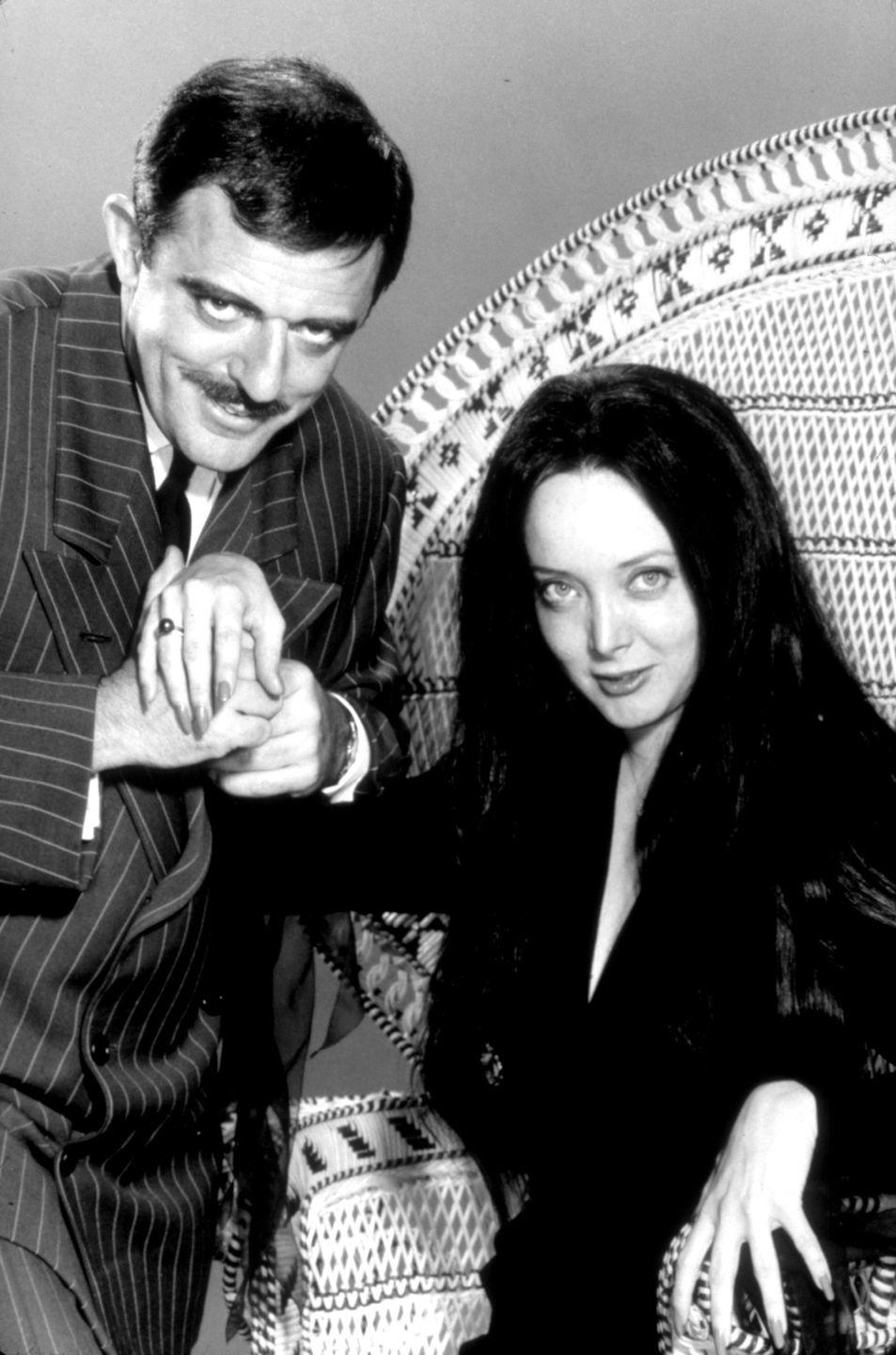 <p>America's favorite creepy, kooky, and altogether doting TV patriarch is the perfect blend of Halloween appropriate and approachable. The keys to the costume? A patterned suit, a killer mustache, and a black-clad "cara mia" to complete the <em>Addams Family</em> vibe. </p>