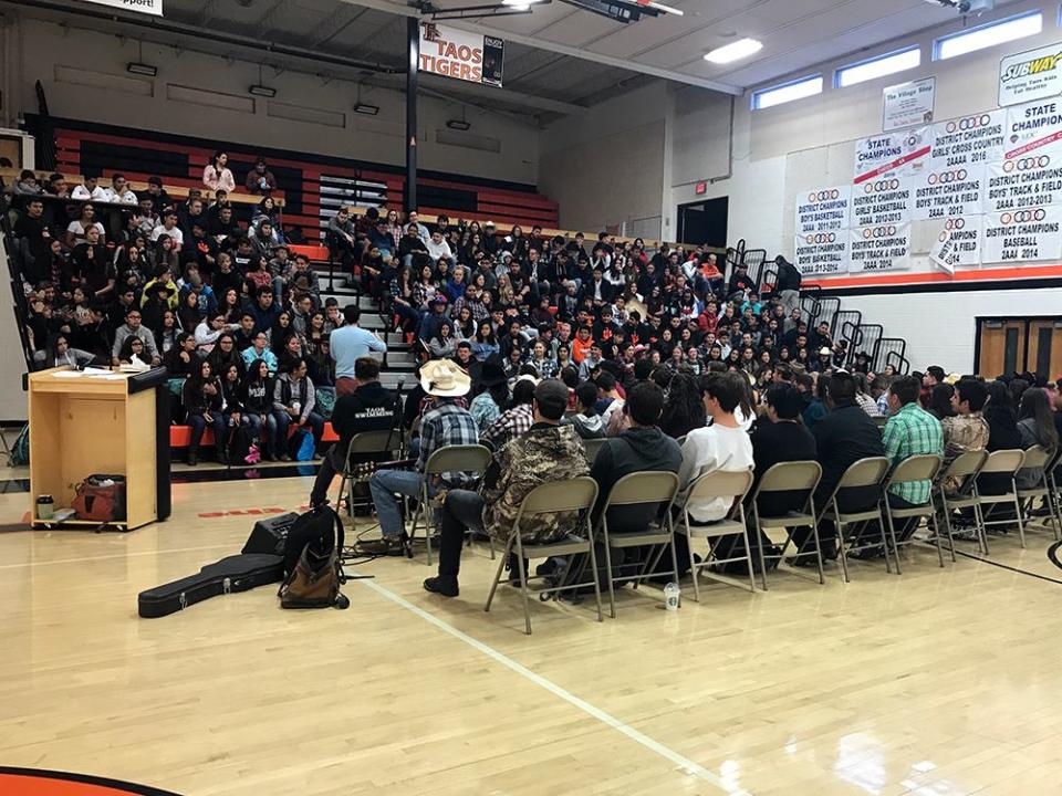 The freshman class at Taos High in New Mexico sat in bleachers to hear from history teacher Ned Dougherty and the seniors who participated in the annual three-day retreat in October.