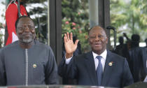 Omar Touray, president of the ECOWAS Commission, left and Ivory Coast President, Alassane Ouattara, arrive ahead of the ECOWAS meeting in Abuja, Nigeria, Saturday, Feb. 24, 2024. Heads of state across West Africa met on Saturday to discuss the region's existential challenges with a renewed plea on junta-led nations to rescind their decision to quit the regional bloc and a plan to review of sanctions it imposed to reverse the coup in Niger. (AP Photo/Gbemiga Olamikan)