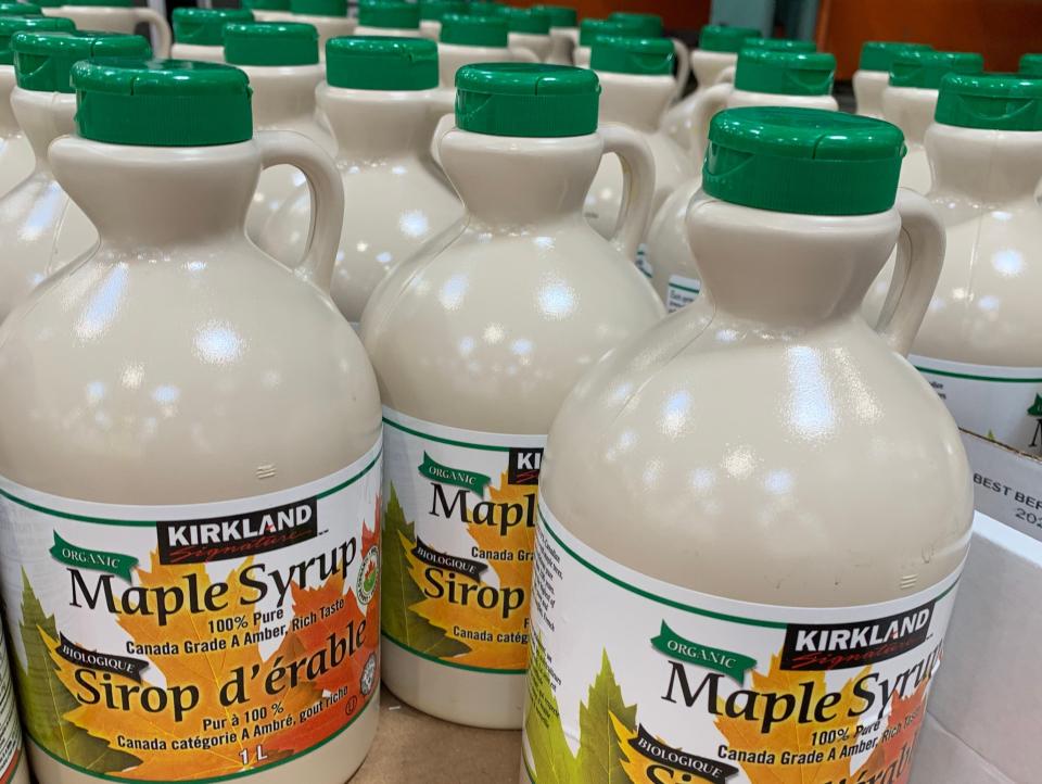 beige jugs of Maple Syrup on a shelf at costco