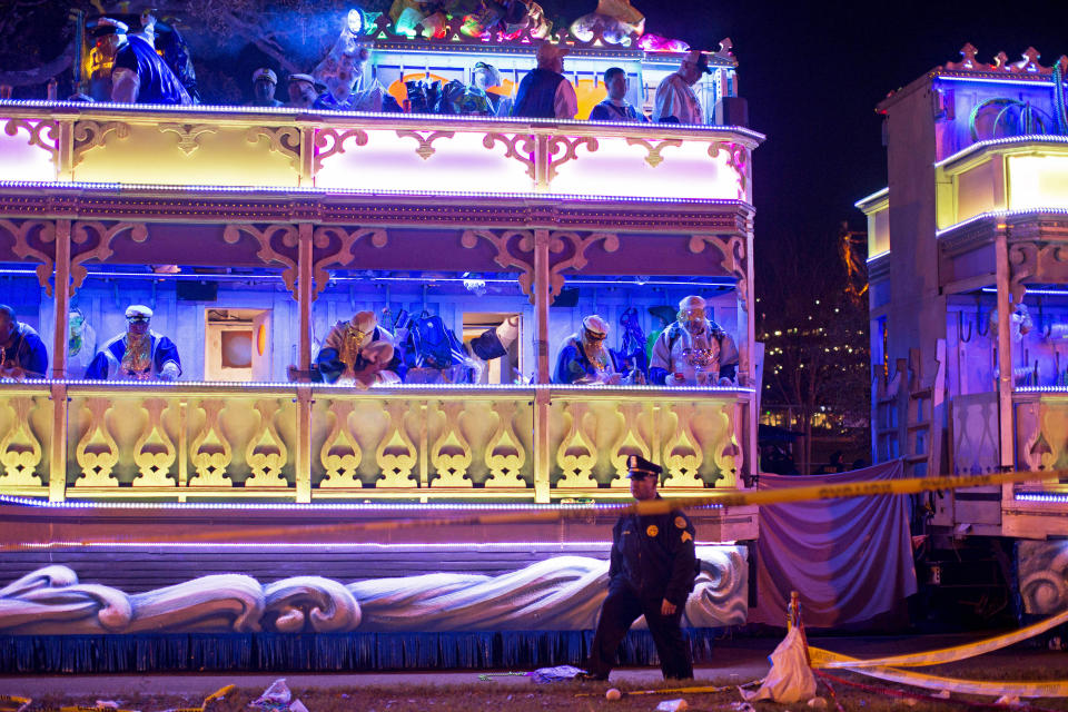 A police officer works the scene where a man was reportedly hit and killed by a float of the Krewe of Endymion parade in the runup to Mardi Gras in New Orleans, Saturday, Feb. 22, 2020. A person was struck by a float and fatally injured Saturday evening during one of the iconic parades of the Mardi Gras season in New Orleans, authorities said. It was the second death in days to mar this year's Carnival festivities. (Max Becherer/The Advocate via AP)