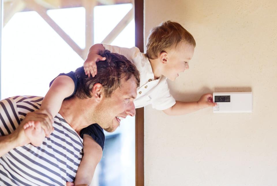 Is it better to cool your house all day, or adjust the A/C setting on your way out the door? <a href="https://www.gettyimages.com/detail/photo/father-carrying-son-on-shoulders-adjusting-royalty-free-image/668763443" rel="nofollow noopener" target="_blank" data-ylk="slk:Westend61 via Getty Images;elm:context_link;itc:0;sec:content-canvas" class="link ">Westend61 via Getty Images</a>