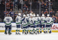 Vancouver Canucks players celebrate the win over the Edmonton Oilers after Game 3 of an NHL hockey Stanley Cup second-round playoff series in Edmonton, Alberta, Sunday, May 12, 2024. (Jason Franson/The Canadian Press via AP)
