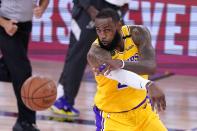 Los Angeles Lakers forward LeBron Jame makes a pass during the second half an NBA conference final playoff basketball game against the Denver Nuggets on Friday, Sept. 18, 2020, in Lake Buena Vista, Fla. (AP Photo/Mark J. Terrill)