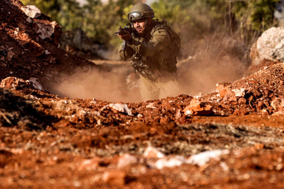 An Israeli army soldier advances during a drill at a position in near the border with Lebanon. (Jalaa Marey / AFP - Getty Images)