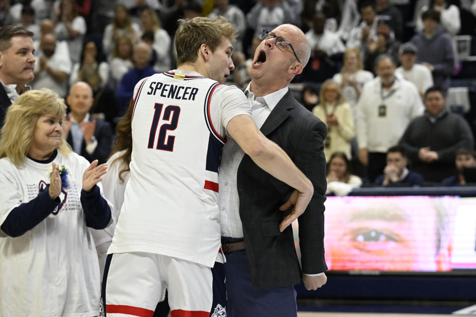 UConn guard Cam Spencer (12) is chest bumped by UConn head coach Dan Hurley as he is introduced for senior ceremony before an NCAA college basketball game against Seton Hall, Sunday, March 3, 2024, in Storrs, Conn. (AP Photo/Jessica Hill)