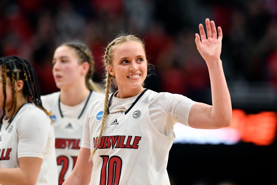 FILE - Louisville guard Hailey Van Lith (10) waves to the crowd at the end of a women's NCAA tournament college basketball second-round game against Gonzaga in Louisville, Ky., Sunday, March 20, 2022. Some star womenâ€™s players have already decided to stay in school rather than make their earliest possible jump to the WNBA and more are on the way with NIL deals and chartered travel offering appeal compared to rookie salaries and commercial flights in the WNBA. (AP Photo/Timothy D. Easley, File)