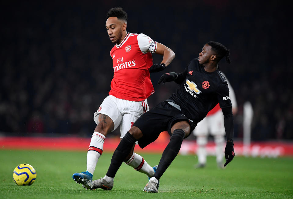 Arsenal's Pierre-Emerick Aubameyang (left) in action with Manchester United's Aaron Wan-Bissaka. 