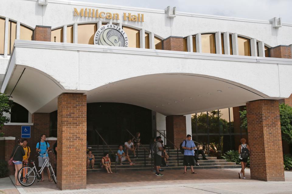 In this Wednesday, Sept. 24, 2014 photo, students gather in front of Millican Hall at the University of Central Florida in Orlando, Fla.