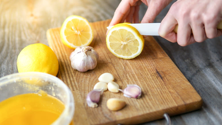 person chopping lemon and garlic