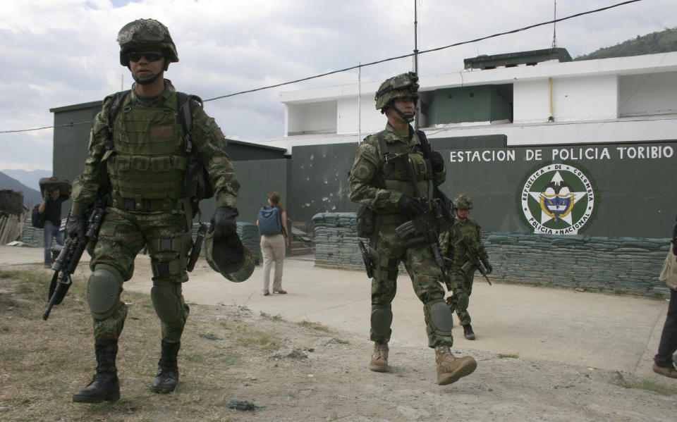 Soldiers patrol in front the police station that was attacked by rebels of the Revolutionary Armed Forces of Colombia (FARC) last week in Toribio, southern Colombia, Tuesday, July 10, 2012. Colombia's President Juan Manuel Santos will visit Toribio on Wednesday. (AP Photo/Juan Bautista)