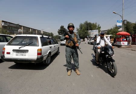 An Afghan police officer inspects vehicles at a checkpoint in Kabul, Afghanistan August 6, 2017. REUTERS/Mohammad Ismail