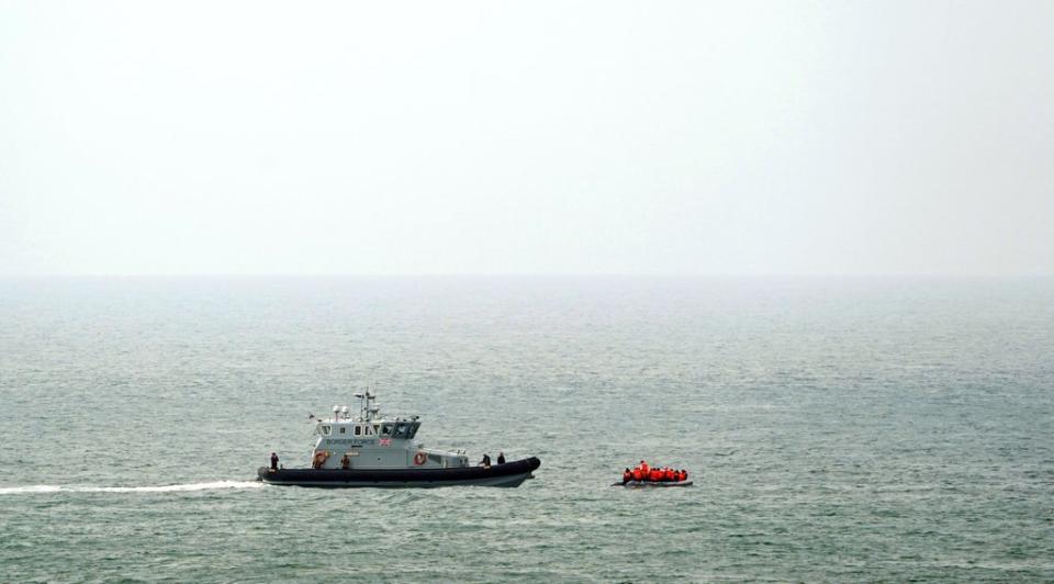 A Border Force vessel intercepts a group of people thought to be migrants in a small boat off the coast of Dover in Kent (PA)