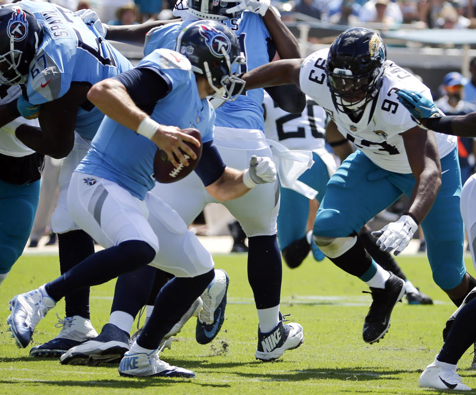 Tennessee Titans quarterback Blaine Gabbert, left, tries to dodge Jacksonville Jaguars defensive tackle Calais Campbell (93) before he is sacked during the first half of an NFL football game, Sunday, Sept. 23, 2018, in Jacksonville, Fla. (AP Photo/Stephen B. Morton)