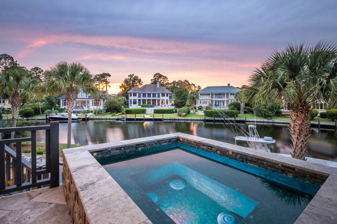 A view of the outdoor living space, including the harborside spa and pool, found at 36 Plumbridge Circle on Hilton Head Island, SC.