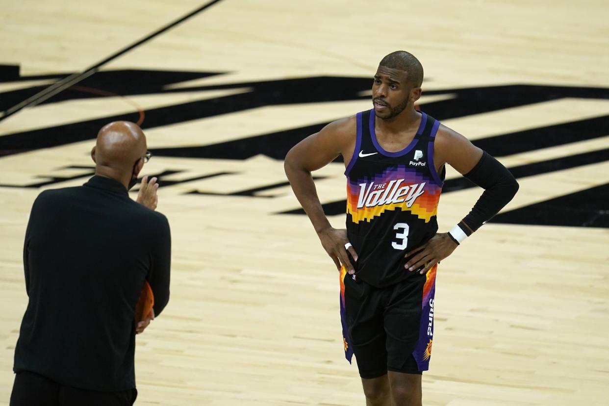 Phoenix Suns guard Chris Paul (3) talks with head coach Monty Williams, left, during the first half of Game 5 of basketball's NBA Finals against the Milwaukee Bucks, Saturday, July 17, 2021, in Phoenix. (AP Photo/Ross D. Franklin)