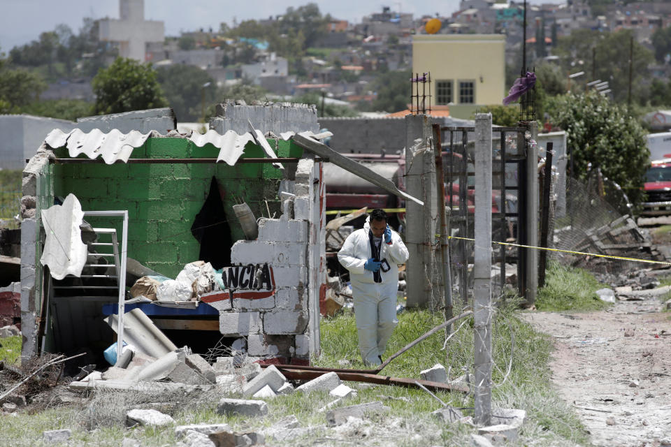 <p>A forensic technician inspects a site damaged due to fireworks explosions in the municipality of Tultepec, on the outskirts of Mexico City, Mexico July 5, 2018. (Photo: Daniel Becerril/Reuters) </p>