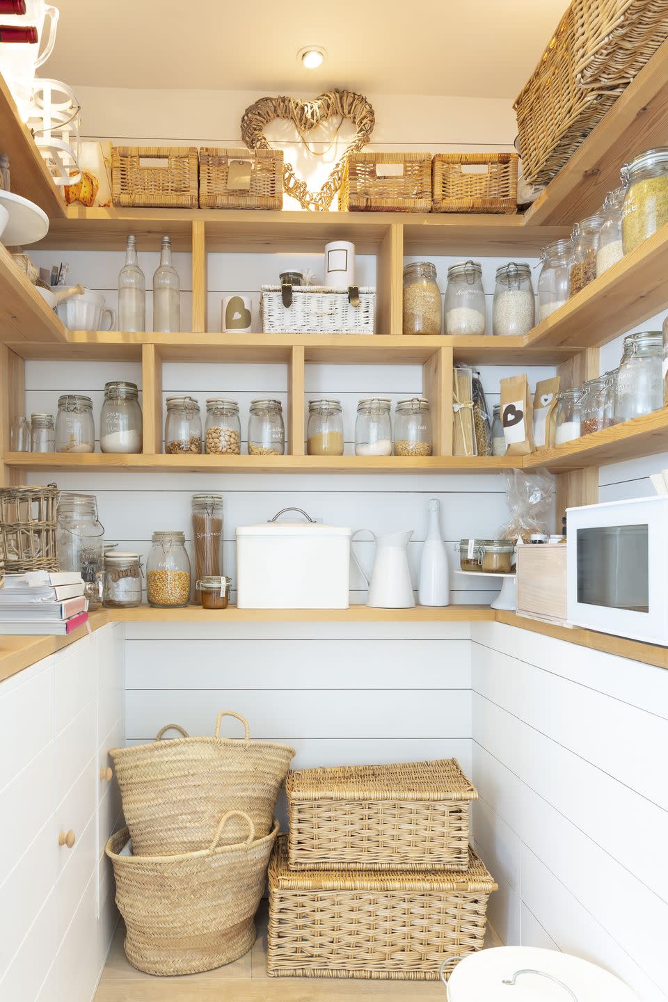 pantry organization ideas, unlabeled glass jars on the shelves in the pantry